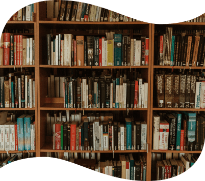 A full bookshelf filled with a wide variety of colorful books, organized across several wooden shelves.